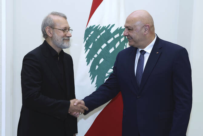 In this photo, released by the Lebanese Presidency press office, Lebanese President Joseph Aoun, right, shakes hands with Iranian Secretary of Supreme National Security Council Ali Larijani, at the presidential palace in Baabda, east of Beirut, Lebanon, Wednesday, Aug. 13, 2025. (Lebanese Presidency press office via AP)