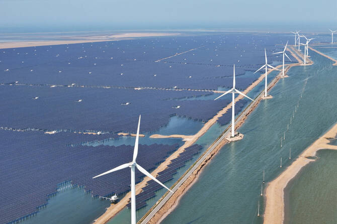 Solar panels and wind turbines are seen at the Huaneng Binzhou new energy power generation project in Shandong, China. (AFP)