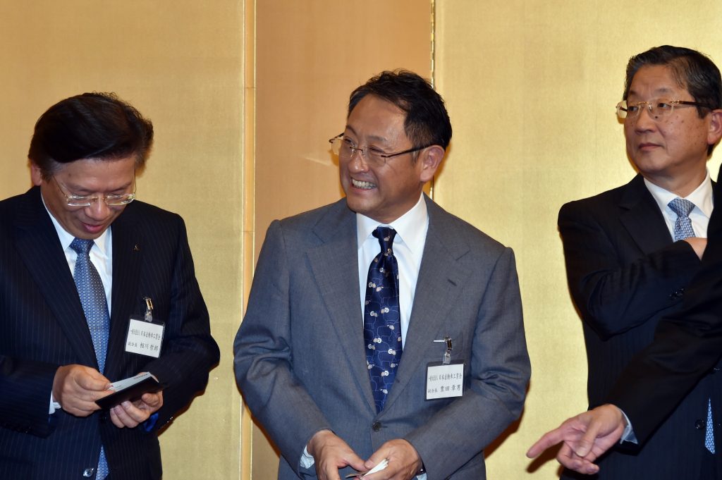 トヨタ自動車の豊田章男社長(中央)、日産自動車の滋賀俊之副会長(右)、三菱自動車の相川哲郎社長(左)。2015年1月6日、東京で撮影。(ファイル 写真/AFP)