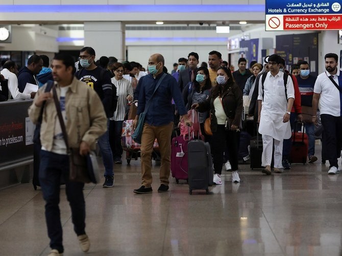ドバイ国際空港に到着する際、マスクをしている旅行者たちもいる。（ロイター/ファイル写真）