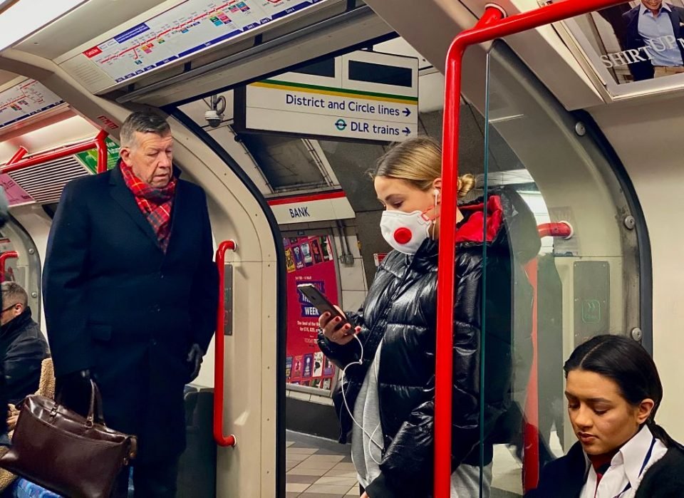 ロンドン地下鉄バンク駅を通り抜ける女性が新型コロナウイルス対策用にマスクを着用している。（Getty Images）