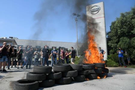 日産の従業員は、工場閉鎖に抗議して、2020年5月28日にバルセロナにある日本の自動車メーカーの工場の前でタイヤを燃やす。(AFP)