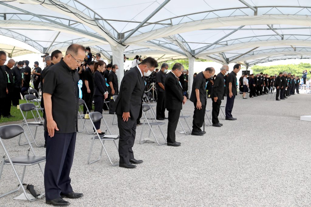沖縄全戦没者追悼式で、席の間隔を空けて黙とうする参列者=23日午後、沖縄県糸満市の平和祈念公園。(File photo/AFP)
