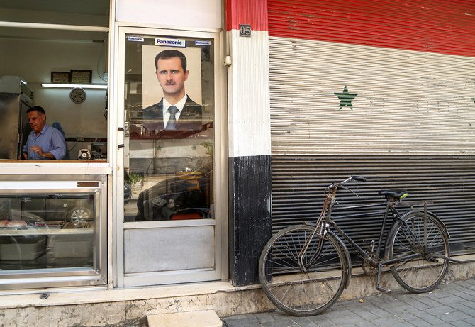 シリアのダマスカスにある精肉店に、バッシャール・アル=アサド大統領の写真が掲げられている。(ファイル/ロイター通信)