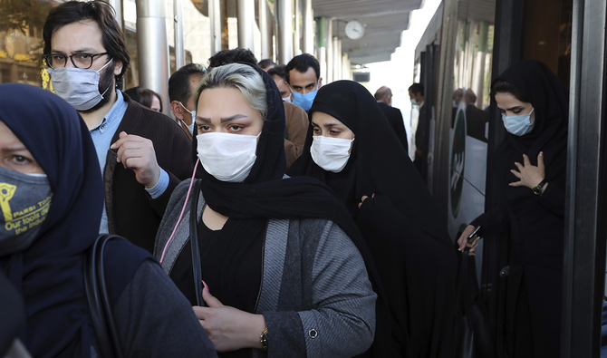 イランのテヘランの繁華街で、新型コロナウイルスの感染拡大を防ぐために防護マスクを着用する人々。(AP/提供)