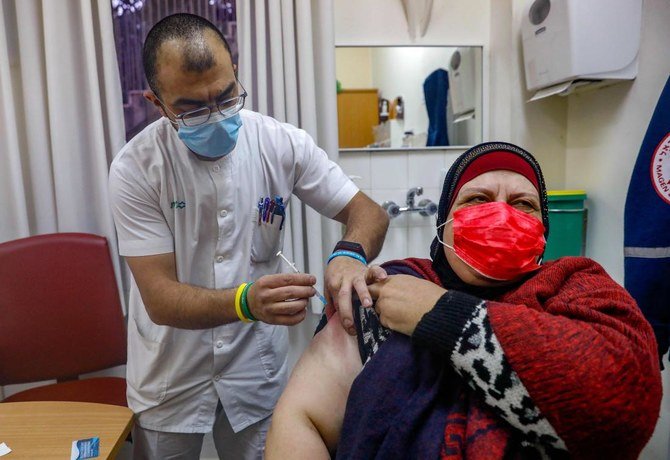 2021年1月30日、イスラエルに併合された東エルサレムのクラリット保健サービス（Clalit Health Services）で、ファイザー・バイオンテック製COVID-19ワクチンの接種を受けるパレスチナ人女性。（AFP通信）