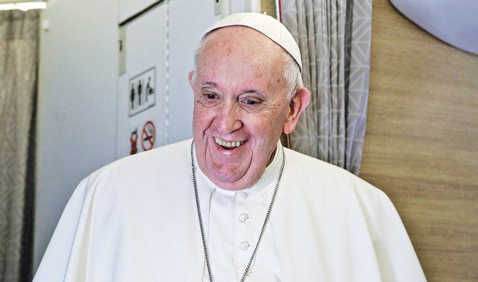 2021年3月8日、イラクからの帰国便であるアリタリア航空の教皇専用機の機内で、記者会見中に笑うフランシスコ教皇（AFP通信）