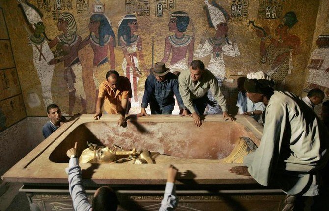 2007 年 11 月 4 日、ザヒ・ハワス (後ろ、左から 3 番目 ) は、ルクソールの王家の谷にある、地下墓標の石棺からツタンカーメン王を運び出す指揮をする。( ロイター )