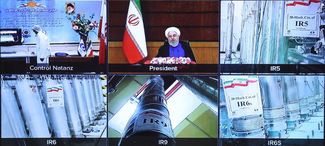 テレビ会議のスクリーンショットは、イラン、ナタンズのウラン濃縮プラントの遠心分離機と、イランのハサン・ロウハーニー大統領が写っている。(AFP通信経由の配布資料)