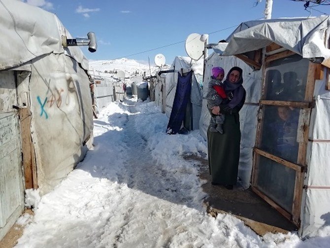 2019年1月9日、レバノン国境の町アルサル近郊の仮設キャンプに身を寄せるシリア人女性とその子ども。（ロイター）
