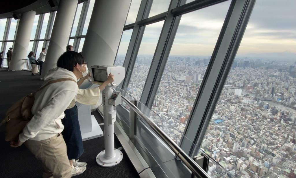 スカイツリーの訪問客が地上350メートルから東京の街を眺める。（ANJ 写真） 