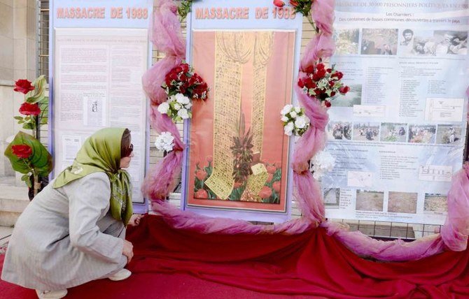1988年のイラン人政治犯の虐待から25周年を記念する記念碑を見つめる女性。フランス、パリ。2013年8月17日。(AFP)