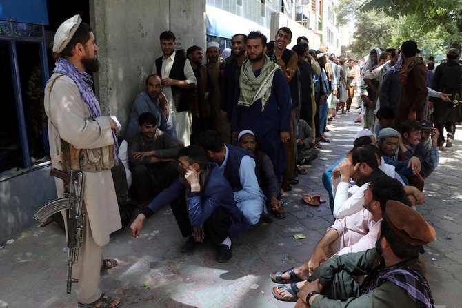 タリバンがアフガニスタンの支配権を奪還した後、カブール銀行の前で待つアフガン人たち。（AP通信）
