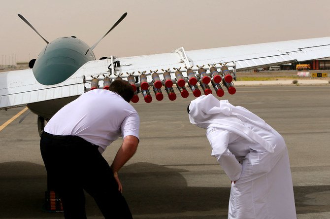 次のクラウドシーディングへの出発前にアル・アイン空港でビーチクラフト機を点検する、国立気象学・地震学センターのパイロットとUAE政府関係者。（AFP/ファイル写真）