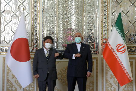 2021年8月22日、イランのテヘランでの会談で、お互いに肘をぶつけて挨拶をするイランのモハンマド・ジャヴァード・ザリーフ外務大臣と日本の茂木敏充外務大臣。(ロイター)