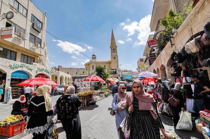 占領下にあるヨルダン川西岸地区のベツレヘム旧市街にある市場で買い物をするパレスチナ人。(AFP)
