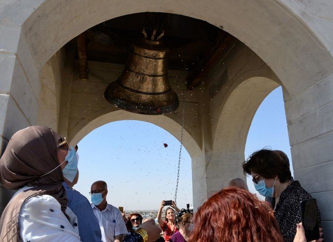 イラク第2の都市モスルにあるシリア系キリスト教のマルトゥマ教会に人々が集まり、新たな鐘の除幕式を祝っている。(AFP)