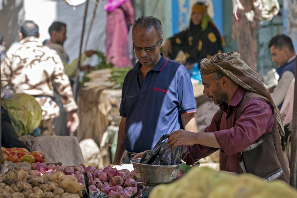 2021年11月4日、紛争状態の長期化で経済・生活環境が悪化する中、イエメン第3の都市タイズの市場で果物や野菜を売るイエメン人の業者。（AFP）