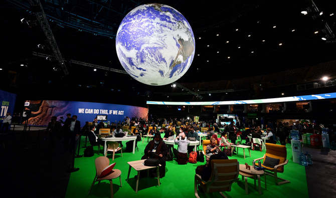 グラスゴーで開催されている国連気候変動枠組条約第26回締約国会議（COP26）の3日目の水曜日にアクションゾーンに座る各国代表団ら。(AFP)