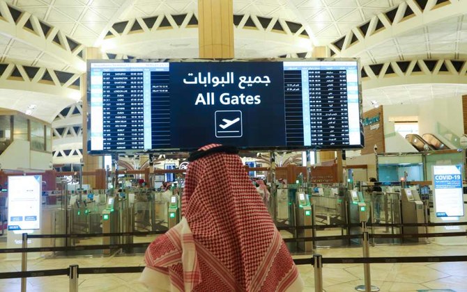 サウジアラビアのリヤドにあるキング・ハーリド国際空港でフライト時刻を確認するサウジアラビア人男性。（REUTERSファイル写真）
