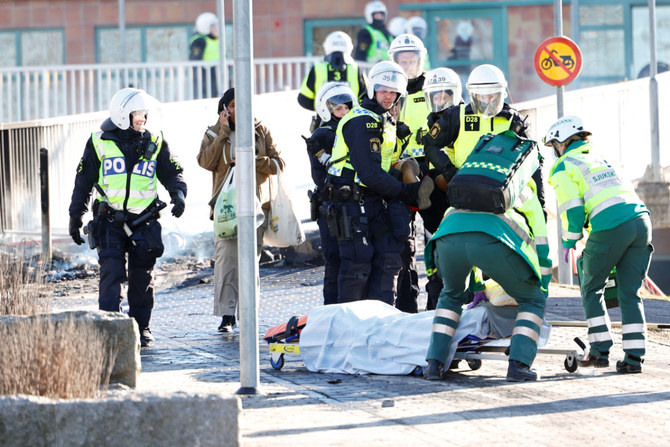 デンマークの反イスラム政治家ラスムス・パルダン氏が巻き起こした暴動で脚を撃たれた男性を運ぶ医療スタッフ。2022年4月17日、スウェーデンのノルショーピンにて。（TT News Agency/ロイターより）