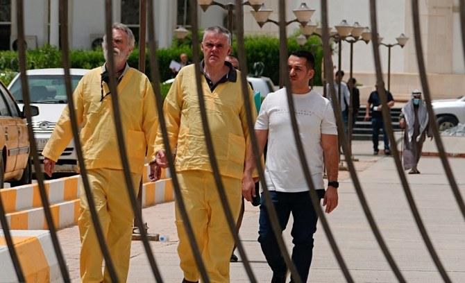 バグダッドの法廷の外で、ジム・フィットン（左）とフォルカー・ヴァルドマン両被告。2022年5月15日(File/AP)