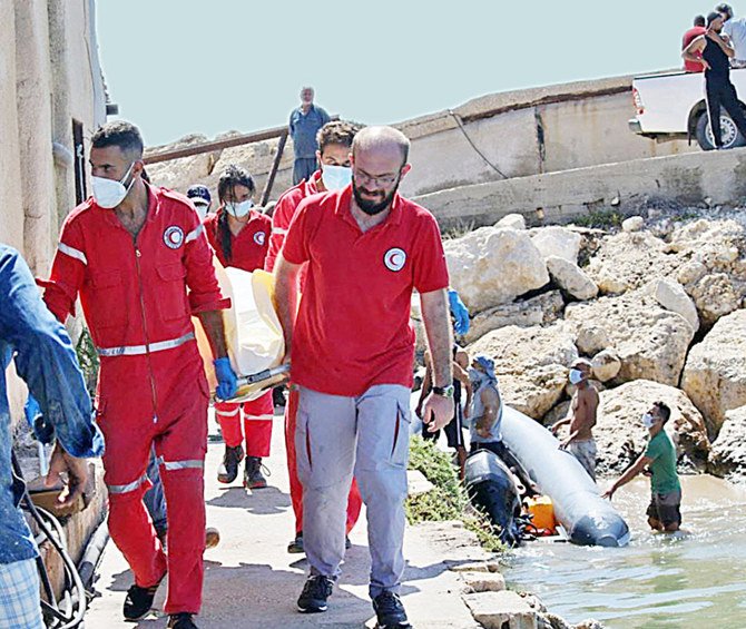 レバノンから不法移民を運ぶ船がシリア沿岸で沈没した後、タルトゥースでシリア赤新月社の職員が犠牲者の遺体を運んでいる。（AFP）