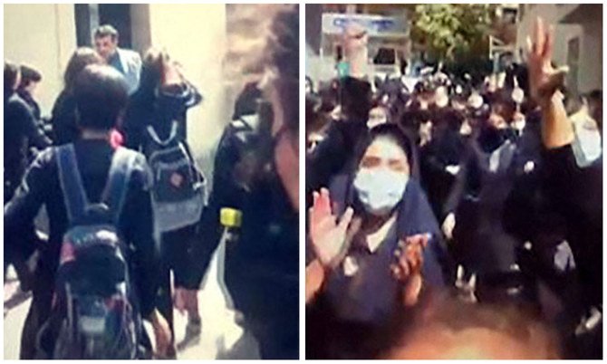 イランのカラジで「独裁者に死を！」と唱えながら、高校の門から出た男性を追いかけ、物を投げつける女子学生たち。（AFP）