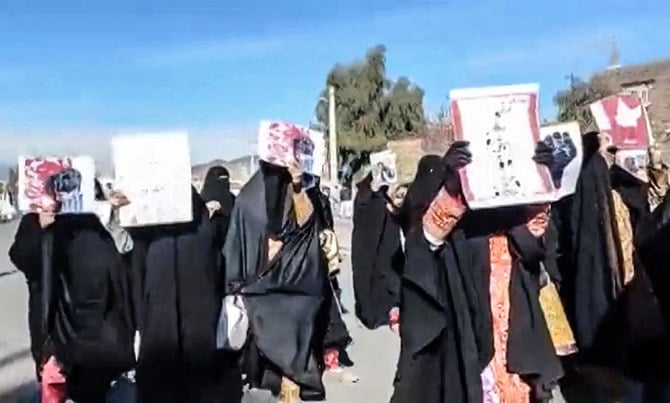 ユーザー投稿動画の一コマに、イランのスィスターン・バルーチェスターン州の街ザーヘダーンで反体制のプラカードを持って行進する女性たちが写されている。（ユーザー投稿動画：AFP経由）