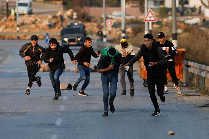 イスラエル国境警察と衝突するパレスチナ人たち。2022年12月8日、ヨルダン川西岸地区ラマッラー近郊のベイト・エル。（ロイター）