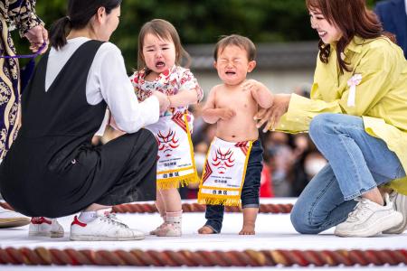2023年4月22日、東京・浅草寺で、新型コロナウイルス感染症の流行後、4年ぶりに再開された「泣き相撲」を、親に抱かれた子どもたちが始める。(A通信)