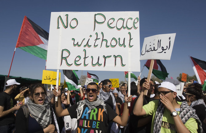 1948年の戦争で難民となったパレスチナ人の帰還権を求めて行進するアラブ系イスラエル人のデモ隊（2012年4月26日撮影）。（AFP）