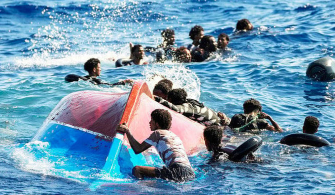 救出作業中の転覆したボートの近くにいる移民たち（AP通信/資料写真）