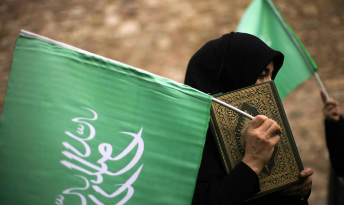 トルコのイスタンブールにあるスウェーデン領事館の前で、抗議活動中コーランを掲げる女性。（AP/資料写真） 
