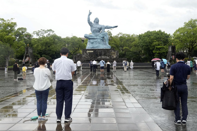 1945年の原爆投下から78年を迎え、原爆死没者に黙祷をささげる人々。台風接近のため、式典は会場を変更し、規模を縮小した。(ファイル／ロイター）