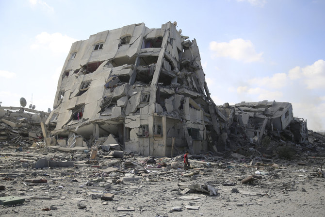 2023年10月20日(金曜日)、ガザ市郊外のアル・ザハラで、イスラエルの爆撃により破壊された建物の側を通りすぎるパレスチナ人の少年。ガザ地区南部の避難区域に退避しなければ、深刻な危機に見舞われるとイスラエル側が警告を発したものの、数十万人のパレスチナ人がガザ地区北部の自宅に留まることを決意した。 (AP写真/アリ・マフムード、ファイル)