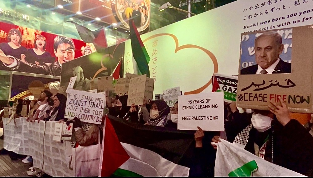 デモ参加者たちは、ガザ保健当局が発表した犠牲者たちの名前を記した長いバナーを掲げて行進した。(ANJ)