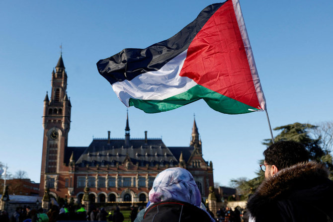 1月にイスラエルによるガザでの軍事作戦は国家主導のジェノサイドであると南アフリカが告発したことを受け、裁判官がイスラエルに対する緊急措置の裁定を下す中、ハーグの国際司法裁判所（ICJ）前に集まって抗議する人々。（File/Reuters）