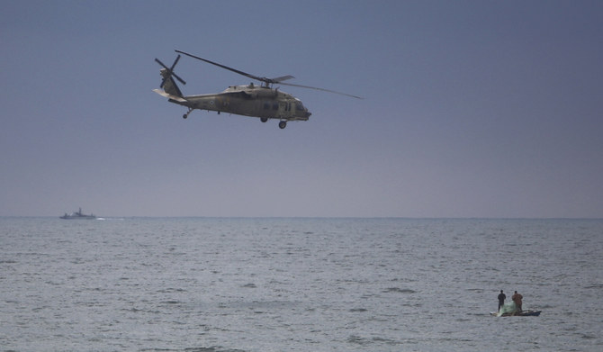 2024年2月15日、ガザ地区のハーン・ユーニス近郊で、パレスチナの漁師たちの上空を飛ぶイスラエルのヘリコプター。(AP)
