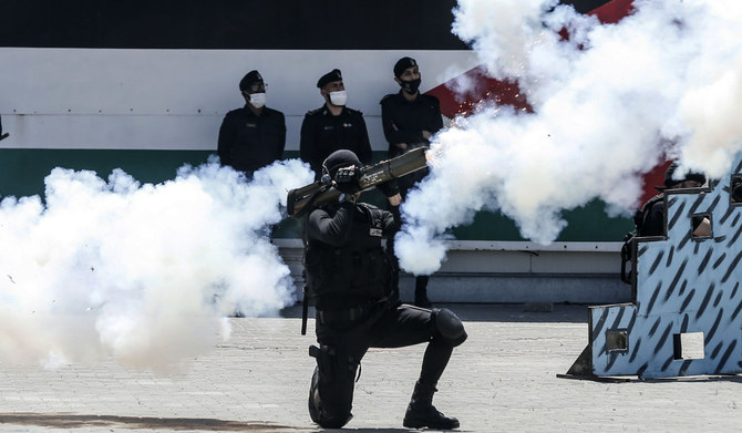 コロナウイルスCOVID-19の感染拡大が懸念される中、ガザ市の警察学校卒業式で技を披露するパレスチナのハマス警察幹部候補生。(AFP）