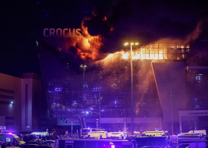 銃撃事件の後、燃え盛るクロッカス・シティ・ホールのコンサート会場の外には、ロシアの救急隊の救急車や車両が駐車されている（2024年3月22日、ロシア・モスクワ郊外）。(ロイター）