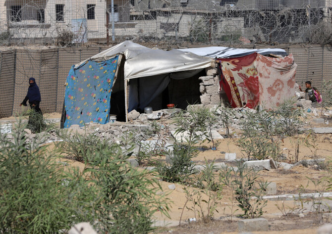 2024年8月15日、イスラエルとハマスの戦争が激化する中、ガザ地区南部ハーン・ユーニスの墓地に避難するパレスチナ人。(REUTERS)