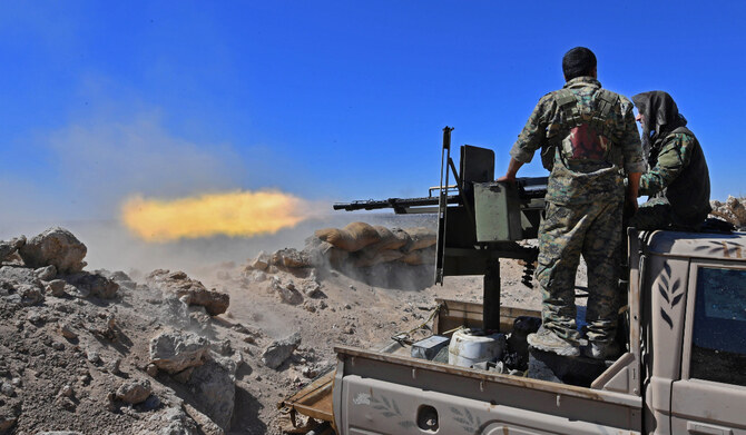 2019年3月18日、シリア東部デリゾール県の田園地帯で、残るダーイシュグループの戦闘員が最後の拠点として立てこもっているバグーズの一部に向かって、シリア民主軍（SDF）の戦闘員がトラック搭載の銃を発砲する。（AFP）
