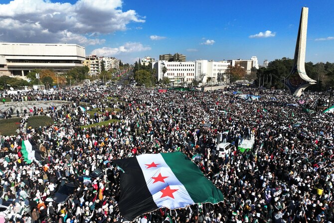 シリアの人々が、ダマスカスの中心にあるウマイヤ広場で、バッシャール・アサドの退陣を祝うために集まっている。2024年12月13日(ファイル/AFP)