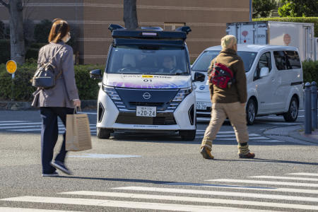 日産自動車が公開したこの写真には、2025年2月に東京近郊の横浜市内の道路を走る同社の自動運転車（中央）が写っている。（日産自動車提供、AP通信）