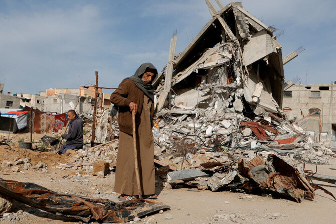 ファイル写真：イスラエルの攻撃で破壊された住宅の瓦礫の近くを歩くパレスチナ人男性（2025年3月13日、ガザ地区南部のラファにて）。（ロイター）