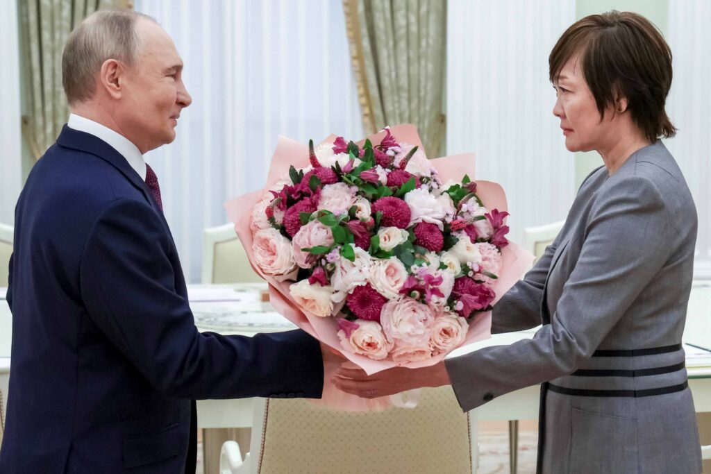 2025年5月29日木曜日、ロシア・モスクワのクレムリン上院宮殿で会談中の安倍晋三元首相の未亡人、安倍昭恵氏に花束を渡すロシアのプーチン大統領(左)。(AP)
