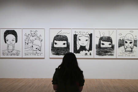 A visitor views artworks by Japanese artist Yoshitomo Nara at the Hayward Gallery in London, Monday, June 9, 2025, the first UK solo exhibition of his work at a public art gallery open to the public from June 10 to Aug. 31. (AP)