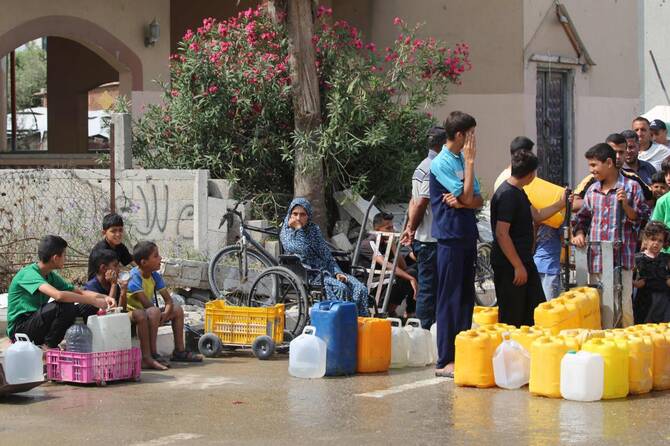 2025年6月23日、ガザ地区中部のヌセイラットの配水ポイントに並ぶパレスチナ人。権利保護団体によると、停戦交渉が暗礁に乗り上げる中、3月初旬にイスラエルが実施した封鎖は、ガザ全域に飢饉のような状況をもたらしたという。(AFP=時事)